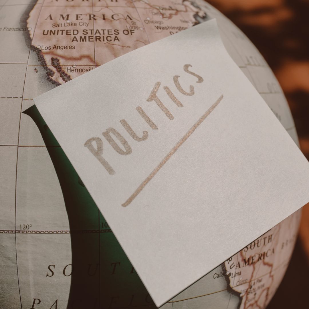 sticky note on a globe that says "politics"